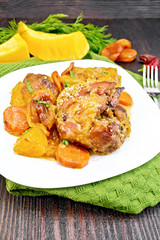Chicken roast with pumpkin and dried apricots on green towel