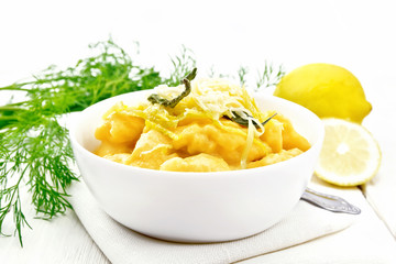 Gnocchi pumpkin with lemon in bowl on board