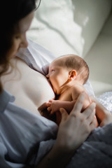 mother feeding her newborn with breast