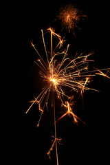 Fototapeta premium yellow sparks on a black background