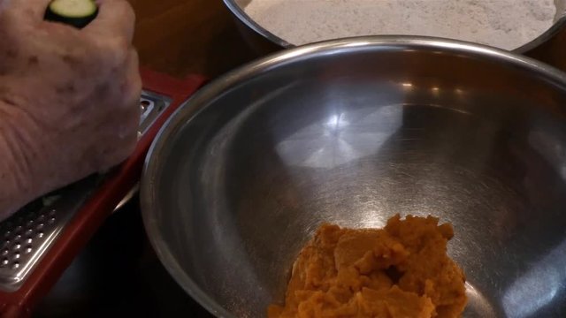 grating zukini into a bowl