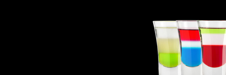 Alcoholic shots green Mexican Kazantip and the Russian flag on a black background. Place for text. Banner.