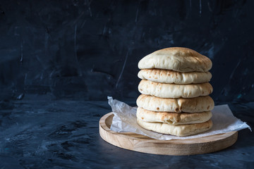 Pita bread on black wooden background with copy space 