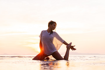 Fototapeta na wymiar Woman on the beach at sunset