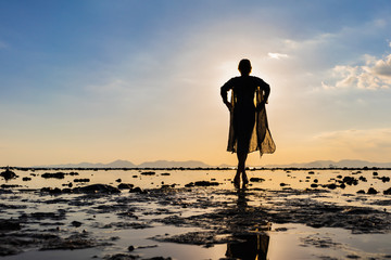 Woman on the beach at sunset