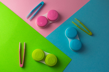 Containers for contact lenses on a colored background