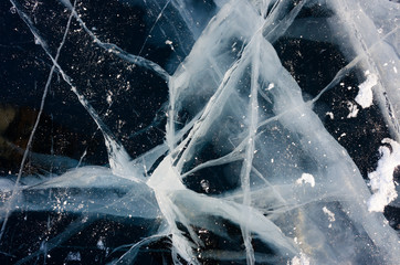 Blue and cold ice of Lake Baikal. Cracks on the ice