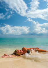 Fototapeta na wymiar Young woman at the tropical beach