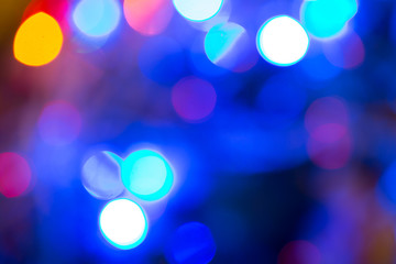 Abstract bokeh background of lights red and orange on a dark