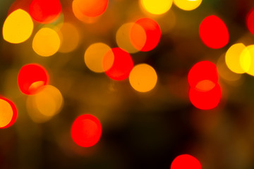 Abstract bokeh background of lights red and orange on a dark