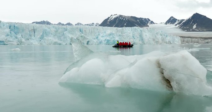 Expedition sailing near iceberg on Rubber zodiak boat in the North Pole 