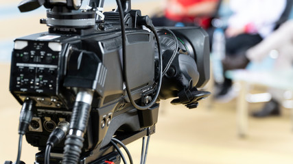 Fototapeta na wymiar Video camera lens - recording show in TV studio - focus on camera aperture