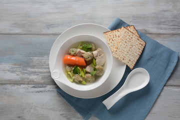 Chicken soup with Matzah balls (Kneidlach) carrots in the bowl. Jewish traditional Passover Pesach holiday food