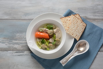 Chicken soup with Matzah balls (Kneidlach) carrots in the bowl. Jewish traditional Passover Pesach holiday food