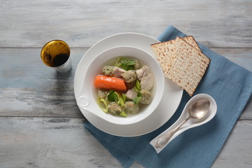 Chicken soup with Matzah balls (Kneidlach) carrots in the bowl. Jewish traditional Passover Pesach holiday food