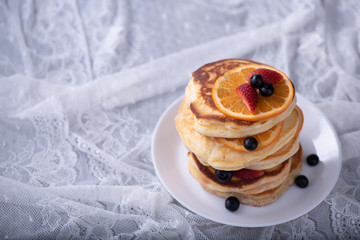 pancake stack with strawberry, blueberry, and orange