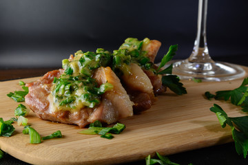 Meat on a wooden board with onions. Delicious food