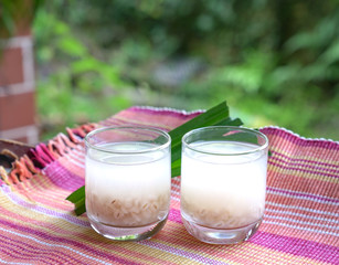 Barley water in glass and cooked pearly barley with pandan leaves