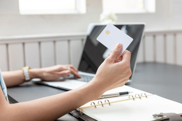 Freelancer business woman using computer laptop and credit cart to shopping online in cafe.