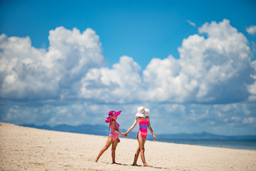 Happy kids travel on a white san tropical ocean beach resort