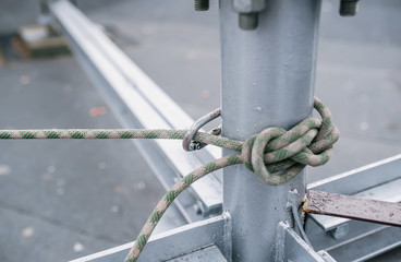 Metal pipe tied by synthetic rope for industrial mountaineering