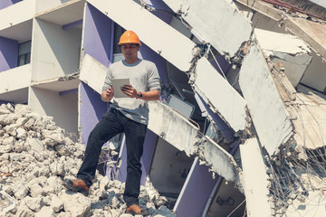 Engineer architect and worker operation control demolish old building.