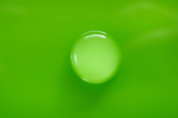 green drop.Round Water drop macro on green background.Conservation concept.Pure water concept. Ecology and nature.Water drop phone wallpapers   