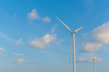 Fototapeta premium Wind energy converter as wind turbine ecology system clean power with blue sky.
