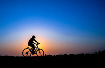 cyclist on sunset background