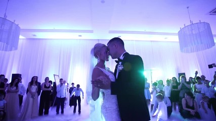 First dance of stylish wedding couple. Handsome groom and elegant bride in the restaurant