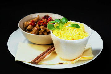 Saffron rice and fried turkey with pepper.