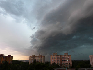 Fototapeta premium Powerful summer thunder storm with dark clouds coming above city Prague, Czech Republic