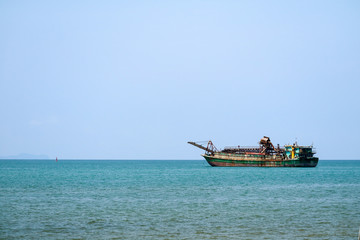 Sand drifting boats floating on horizo line in sea