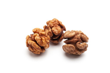 Three pieces of whole peeled walnut on white background