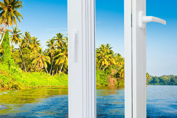 landscape with sea, palms and blue sky outside open window