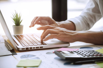 Businessman analyst using on laptop in a modern office.