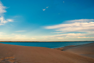 Fototapeta na wymiar The late afternoon sun casts shadows across the sand dunes at Adolfo Lopez Mateos in Baja California, Mexico