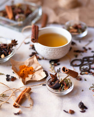 Indian spa, relaxation,  herbal tea ceremony. Dry leaves, spices, cinnamon, anise, curcuma, dry fruits and vegetables. Vintage scissors, craft paper and rope as decoration