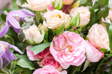 Two wedding rings in flowers. Close up. Engagement