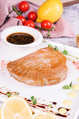grilled salmon steak with sauce and vegetables