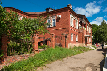 Fototapeta na wymiar Borovichi, Russia - August 8, 2018: Residential building in the city center. Novgorod region, Borovichi, Russia