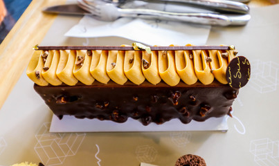 Closeup of piece chocolate cake on the wooden plate