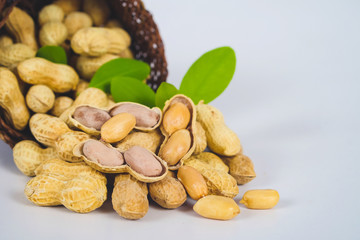 Peanut spill out of basket on background.