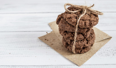a stack of chocolate biscuits tied with rope on kraft paper