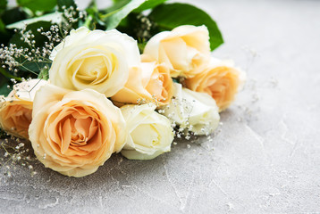Yellow and white roses on a stone background