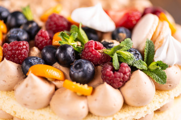 Fresh delicious homemade cake with berries on wooden table