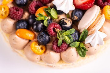 Fresh delicious homemade cake with berries on wooden table