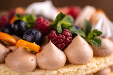 Fresh delicious homemade cake with berries on wooden table