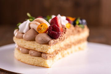 Fresh delicious homemade cake with berries on wooden table
