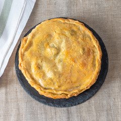 Beautiful fresh homemade round pie, top view - abstract puff pastry pie
